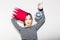 Young smiling woman celebrating party, wearing stripped dress and red paper crown, happy dynamic carnival disco ball