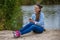 Young smiling woman in excellent spirits with a phone and listens to music