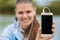 Young smiling woman in excellent spirits with a phone and listens to music