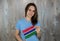 A young smiling woman with a Gambia flag in her hand.
