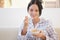 Young smiling woman having cereal breakfast