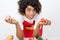 Young smiling woman holding fresh vegetables in her kitchen