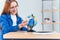 Young smiling woman holds in hand airplane model. Happy beautiful girl planning vacation trip.