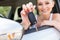 Young smiling woman sitting in car taking key