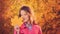 Young smiling woman with yellow autumn leaf, autumn time