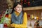 Young smiling woman in a yellow knitted sweater and scarf. Concept home, comfort, lifestyle, autumn, winter, cafe