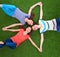 Young smilling women lying on green grass