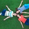 Young smilling women lying on green grass