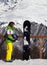 Young snowboarder with helmet in hands and snowboard on viewpoint in winter mountain