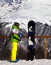 Young snowboarder with helmet in hands and snowboard on viewpoint in winter mountains