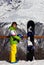 Young snowboarder with helmet in hands and snowboard on viewpoint in winter mountains at sun day
