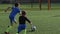 Young soccer forward taking pass and scoring goal