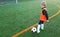 Young Soccer Player Kicking Ball on Soccer Pitch. Boy in Sports Clothing Playing Football. Child Training Soccer with Soccer