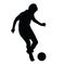Young soccer player passes the ball silhouette
