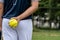 A young Softball player ready to peatch from his position in the outfield.holding a Softball ball in his hands while playing catch