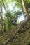 young soldier in military outfit climbing on a steep slope