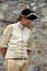 Young soldier standing quietly in front of stone wall,Fort Ticonderoga,New York,2014