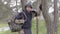 Young soldier in uniforms and tactical vest works in the forest and prepares for action at a temporary forest base.