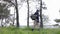 Young soldier in uniforms and tactical vest works in the forest and prepares for action at a temporary forest base