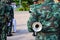 A young soldier wearing a uniform, holding a trumpet instrument, standing, turning back as a background image