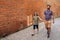 Young son and father walking together along cobblestone streets