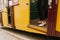 Young sophisticated woman in black dress and white shoes getting off a train