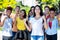 Young south american female student with group of cheering young adults