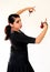 Young Spanish gipsy woman dancing flamenco with brown castanets.