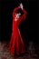 Young Spanish woman dancing flamenco in traditional red dress