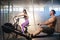 Young sport couple doing exercises on the simulators in the gym.