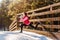 Young sport woman doing exercises during winter training outside.