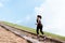 Young sport woman running outdoor upstairs on blue sky