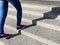 Young sport woman running up on stone stairs with sun spot background. Healthy lifestyle, workout and diet concept