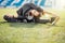 Young sport woman in white stretching in park on the grass