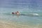 Young sporting man swims in the sea