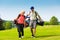 Young sportive couple playing golf on a course