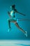 Young sportive girl in white sportswear training with sports expanders isolated over blue studio background in neon