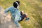 Young sportman wearing headphone to listen music and practicing push ups in a park