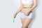 Young sports a beautiful slim woman measuring perfect shape nice hips, the concept of a healthy lifestyle on a white background