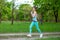 A young sports girl running in a quit green summer forest. Sport and wellness