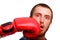 A young sports man-boxer poses to the camera. Man got a punch to the face by red boxing glove