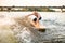 Young sports man wakesurfer balancing on the wave