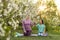 Young sports mother doing physics exercise outdoors in garden near her daughter. Healthy lifestyle. Yoga. Fitness