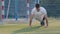 Young sportsman footballer Indian guy in summer sportswear doing biceps push up exercises, exercising arms during