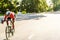 Young sportsman in helmet riding racing bicycle while working out