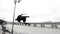 Young sportsman jumps street acrobatic parkour, slow-motion