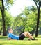 Young sportsman lying on a mat in a park