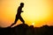 Young Sportsman Running on the Rocky Mountain Trail at Sunset. Active Lifestyle