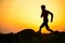 Young Sportsman Running on the Rocky Mountain Trail at Sunset. Active Lifestyle