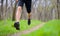 Young Sportsman Running on the Spring Forest Trail in Morning. Legs Close up View